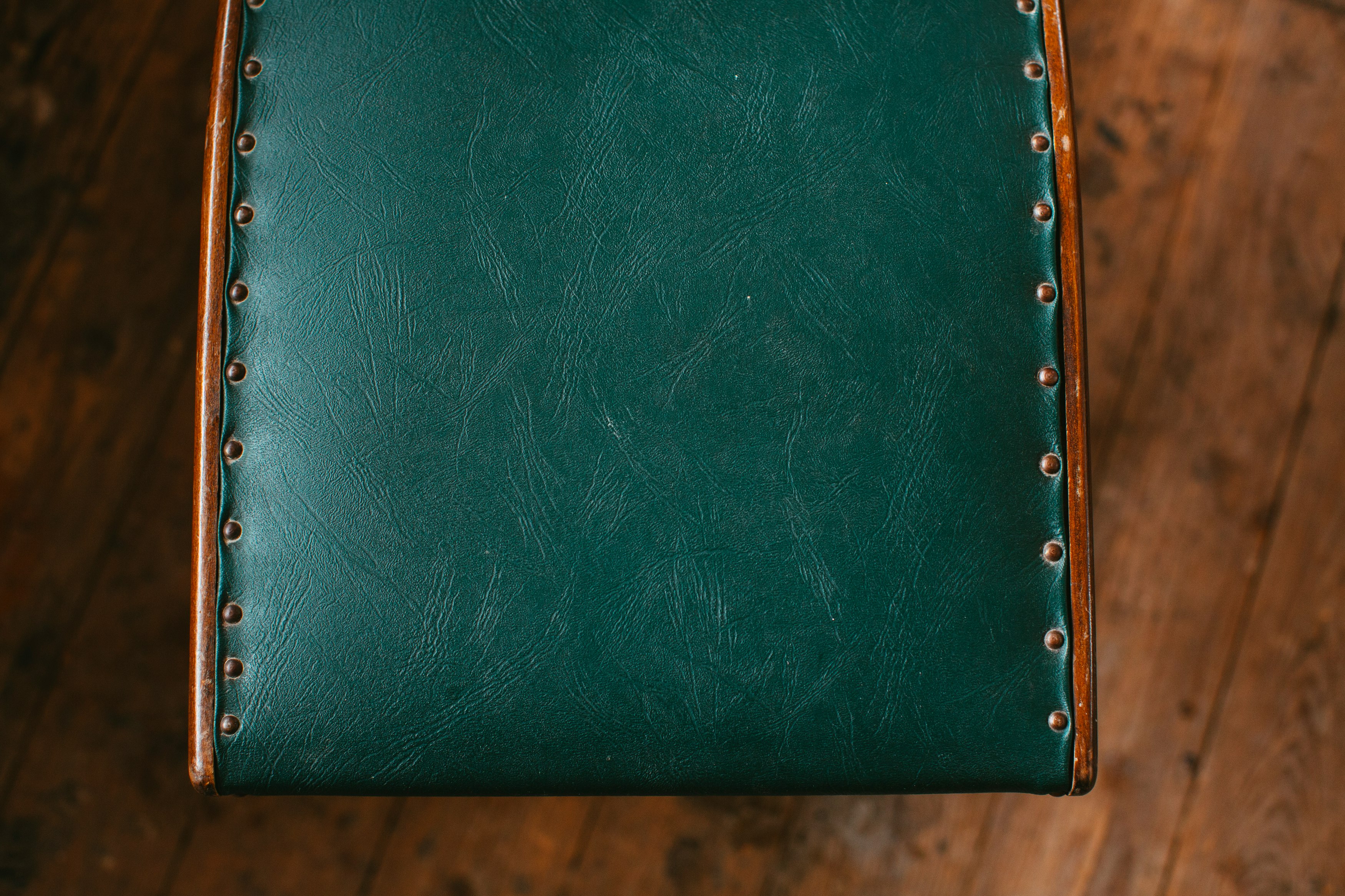 green leather wallet on brown wooden table